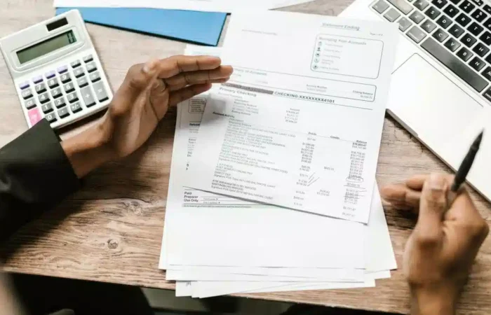 Financial documents, a calculator and laptop arranged on a desk — Portugal Student Visa Proof of Funds