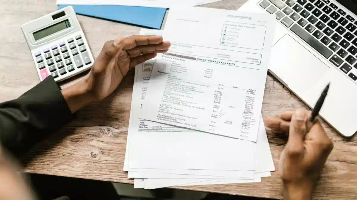 Financial documents, a calculator and laptop arranged on a desk — Portugal Student Visa Proof of Funds