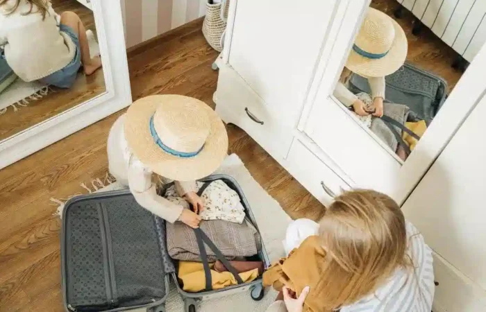 A parent and child packing a suitcase together — studying in Portugal with spouse children