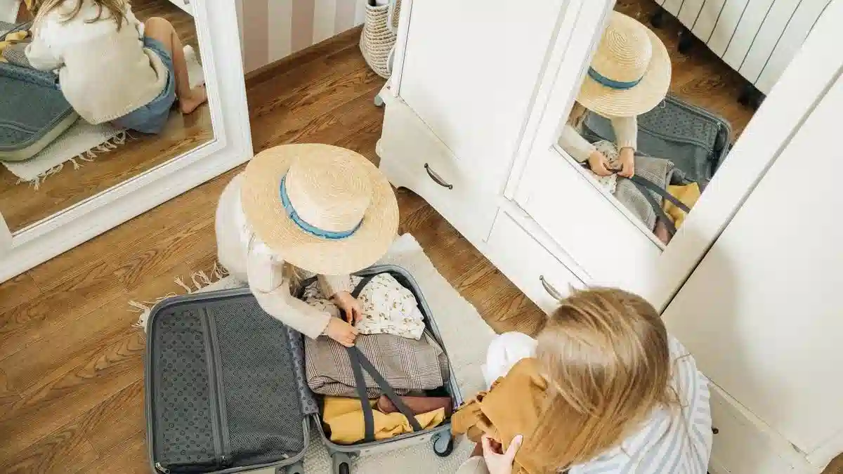 A parent and child packing a suitcase together — studying in Portugal with spouse children