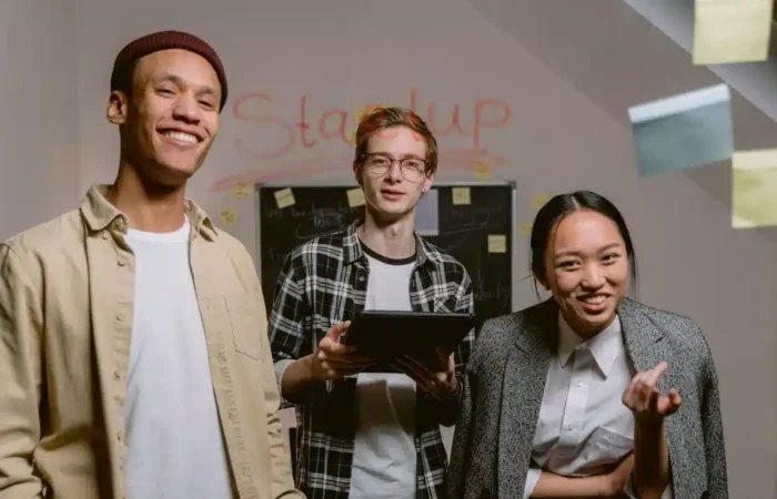 Young professionals working together in a startup office — Portugal Startup Visa incubator acceptance