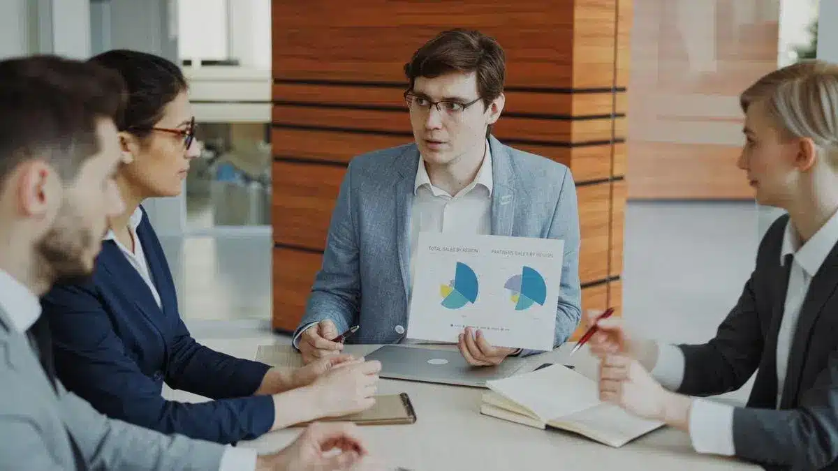 A business team evaluating charts during a formal meeting — Portugal Startup Visa evaluation criteria
