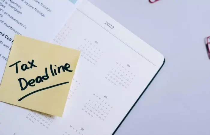 A tax deadline reminder placed on a calendar with financial documents — Portugal digital nomad tax residence