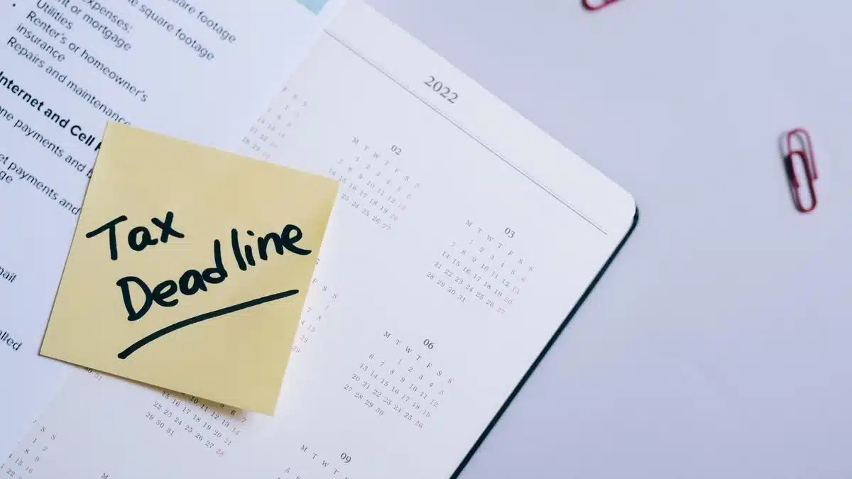 A tax deadline reminder placed on a calendar with financial documents — Portugal digital nomad tax residence