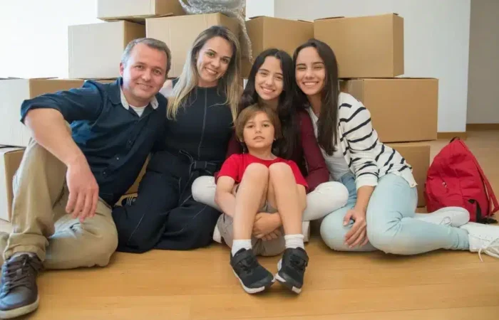 A family sitting together among moving boxes in a new home in Portugal — Portugal digital nomad visa family spouse children