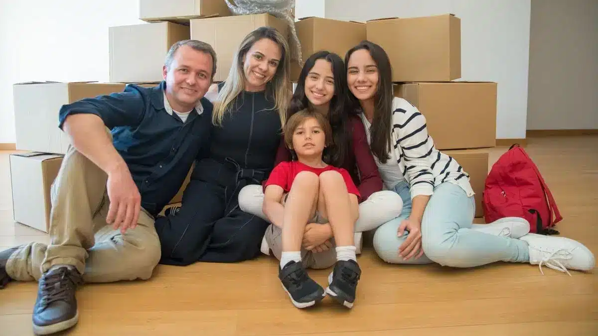 A family sitting together among moving boxes in a new home in Portugal — Portugal digital nomad visa family spouse children