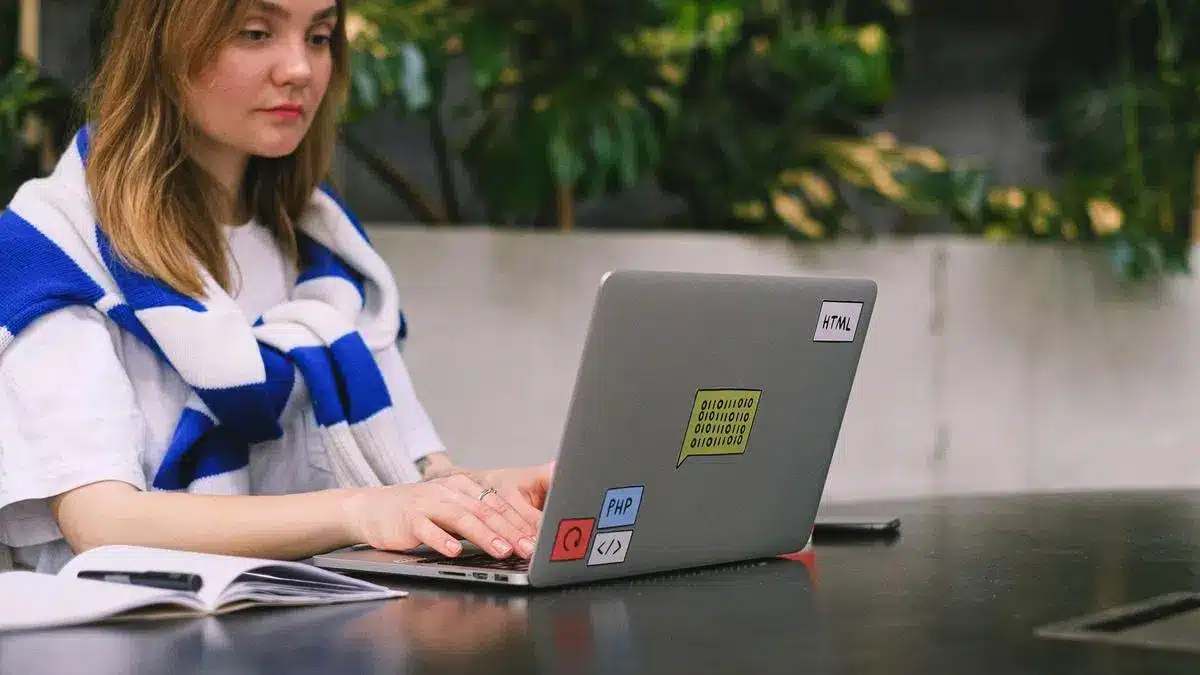 A freelancer working on a laptop in a modern indoor workspace — Portugal digital nomad visa freelancer