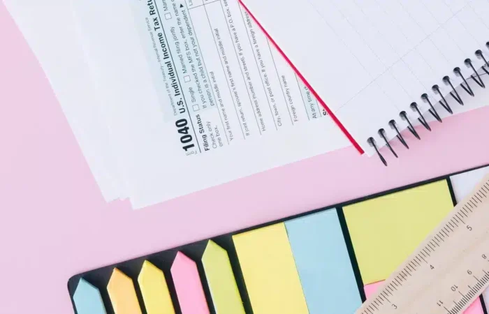 Tax and financial documents arranged with a calculator and notebook — how to get NIF Portugal foreigner