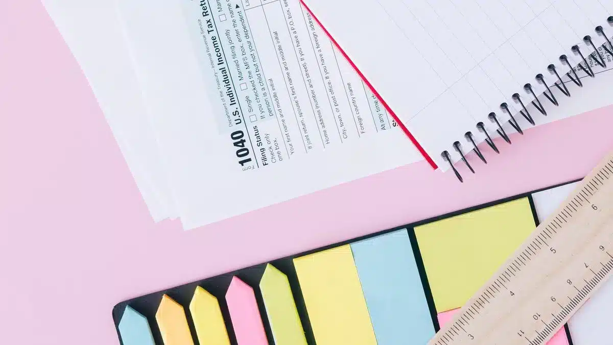 Tax and financial documents arranged with a calculator and notebook — how to get NIF Portugal foreigner